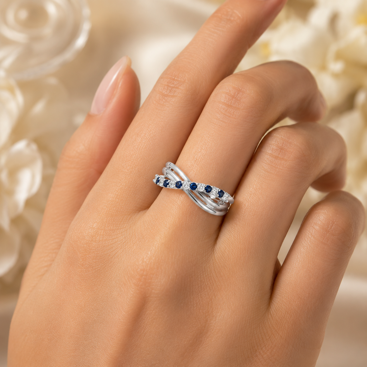 Woman wearing 925 silver CVD diamond ring with blue stone detailing